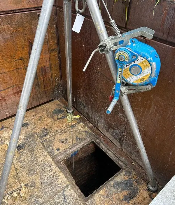 Confined space entry equipment set up over a manhole