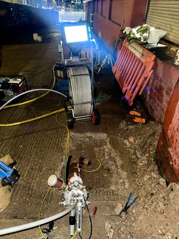 Lining rig and CCTV unit set up on a commercial site at night