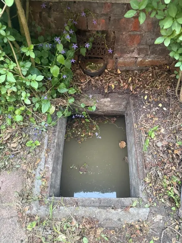 Blocked chamber full of waste before clearing