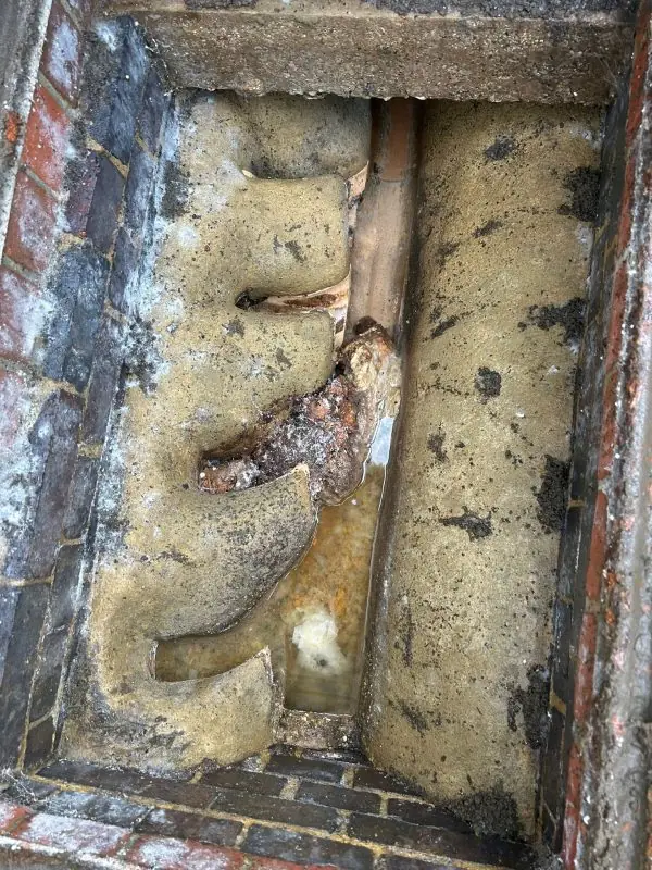 Manhole blocked with debris